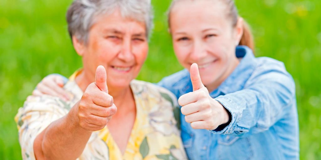 Préposée et bénéficiaire souriantes